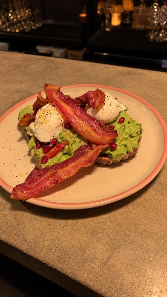 Avocado toast with bacon and poached eggs